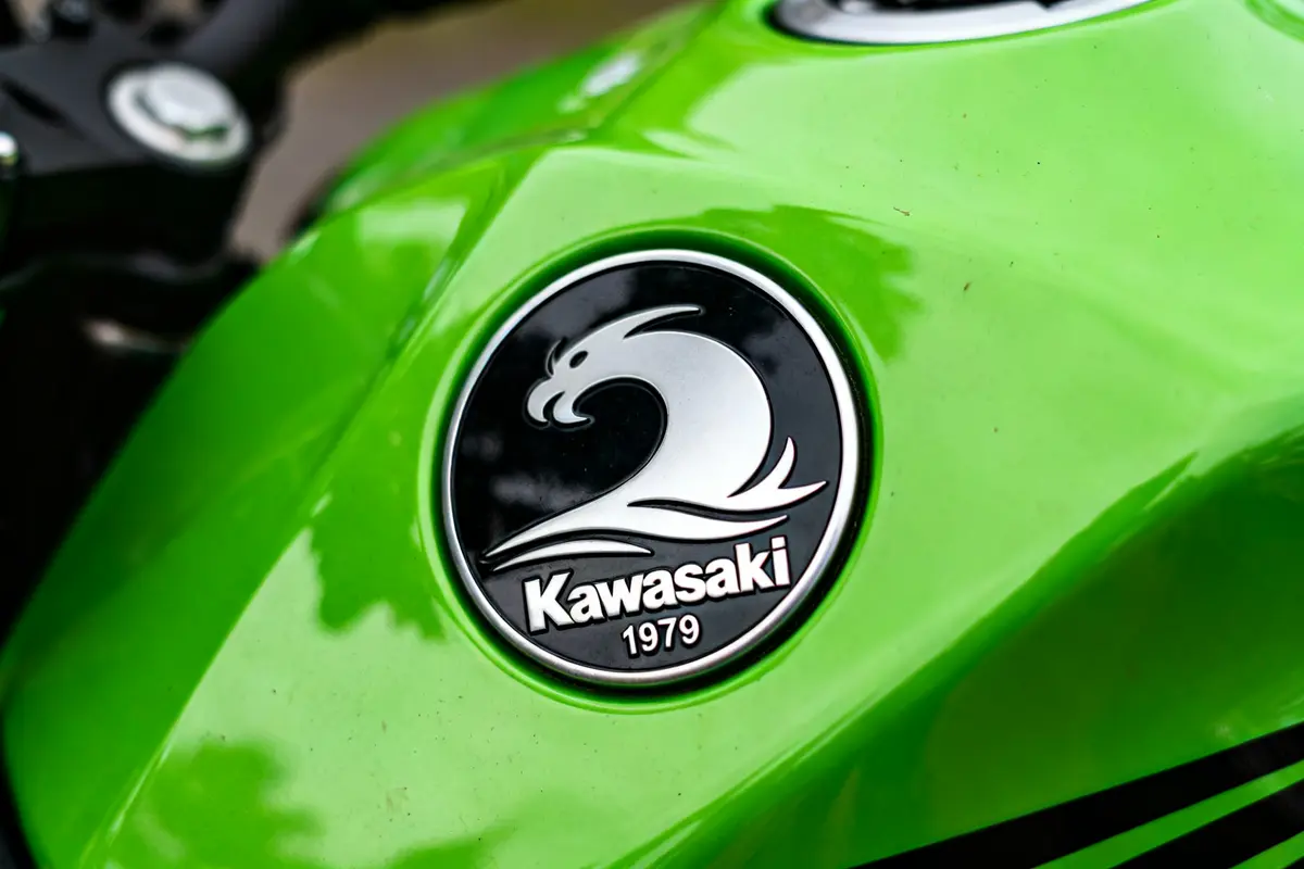 Moto verte avec Kawasaki logotipo dragon argenté sur réservoir